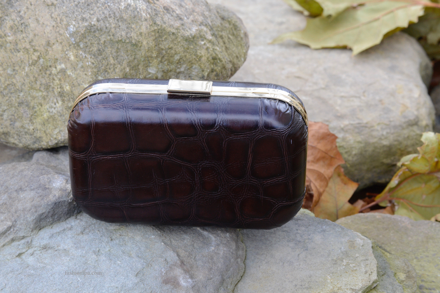Brown crocodile leather box clutch with rounded edges. 