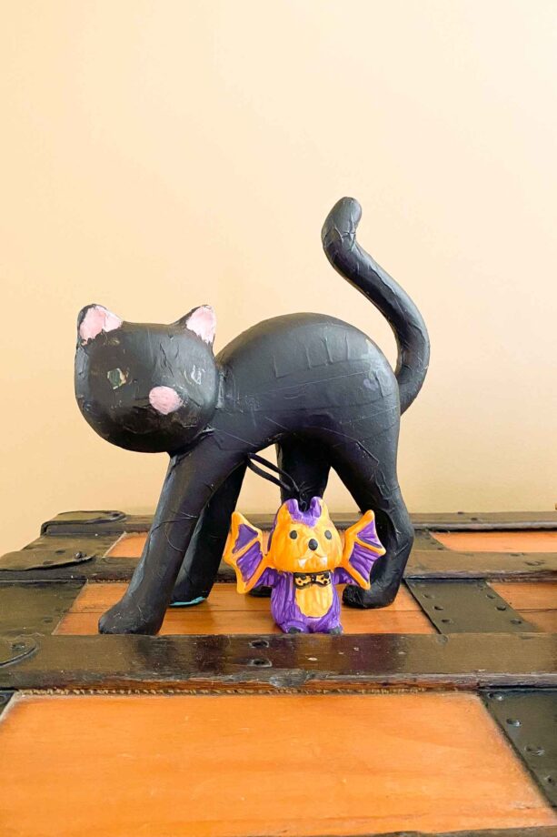 Paper Mache Cat (painted black) And Clay Bat (orange, black, and purple)