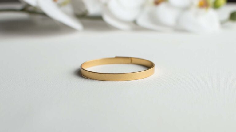 Gold bangle on a white background