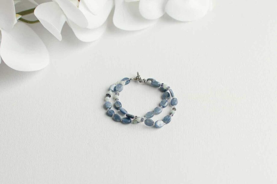 Blue double strand beaded bracelet on a white background