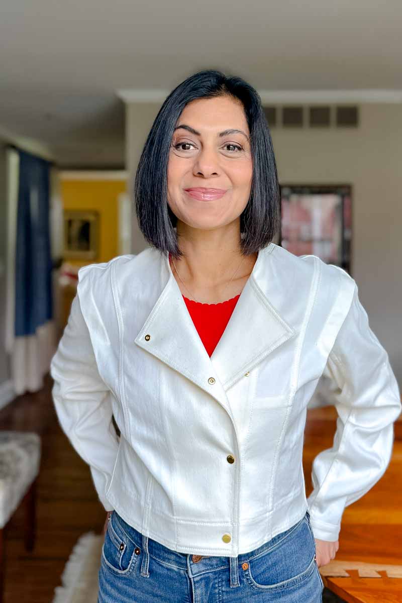 Fashionipa (nipa) wearing a white collarless jacket with a red tee and jeans.