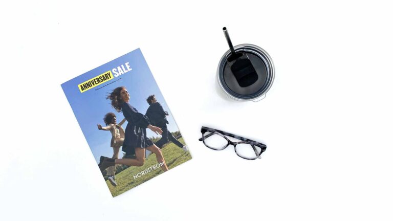 2021 Nordstrom anniversary Sale catalog, reading glasses and travel cup with straw.