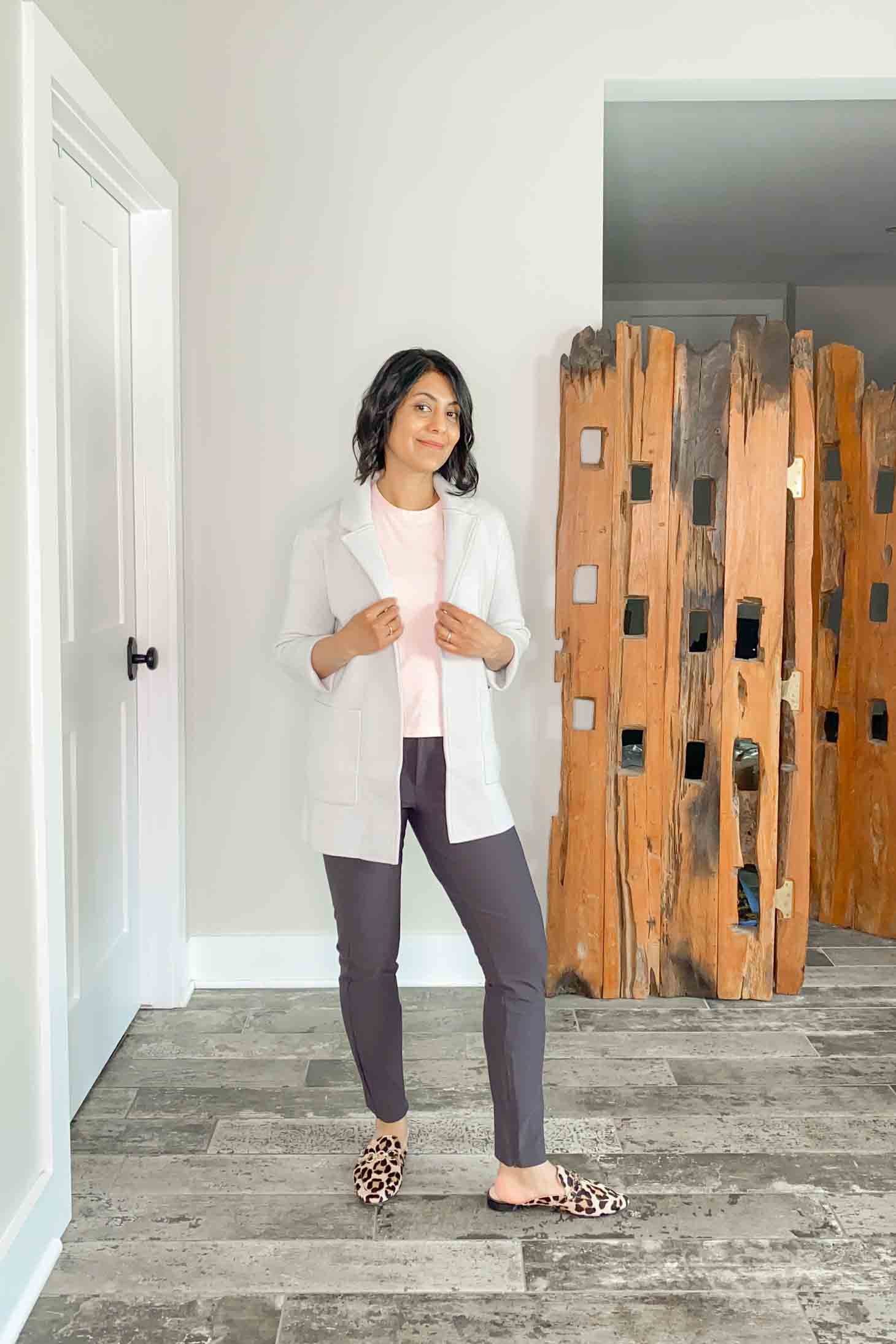 Fashionipa in gray sweater blazer, pink t-shirt, taupe pants and pink leopard mules.