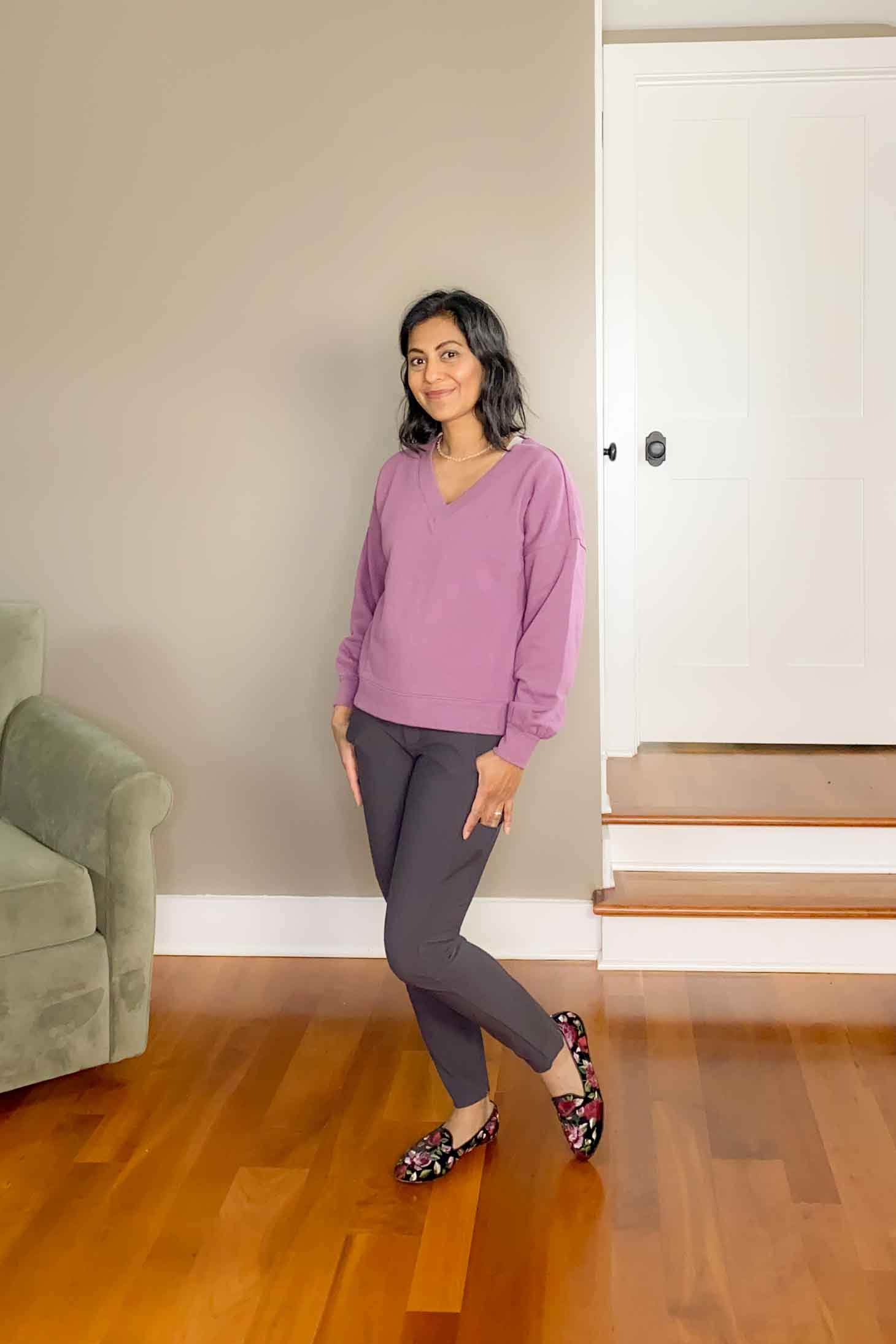 Fashionipa in a violet sweatshirt, slate pants and loafers