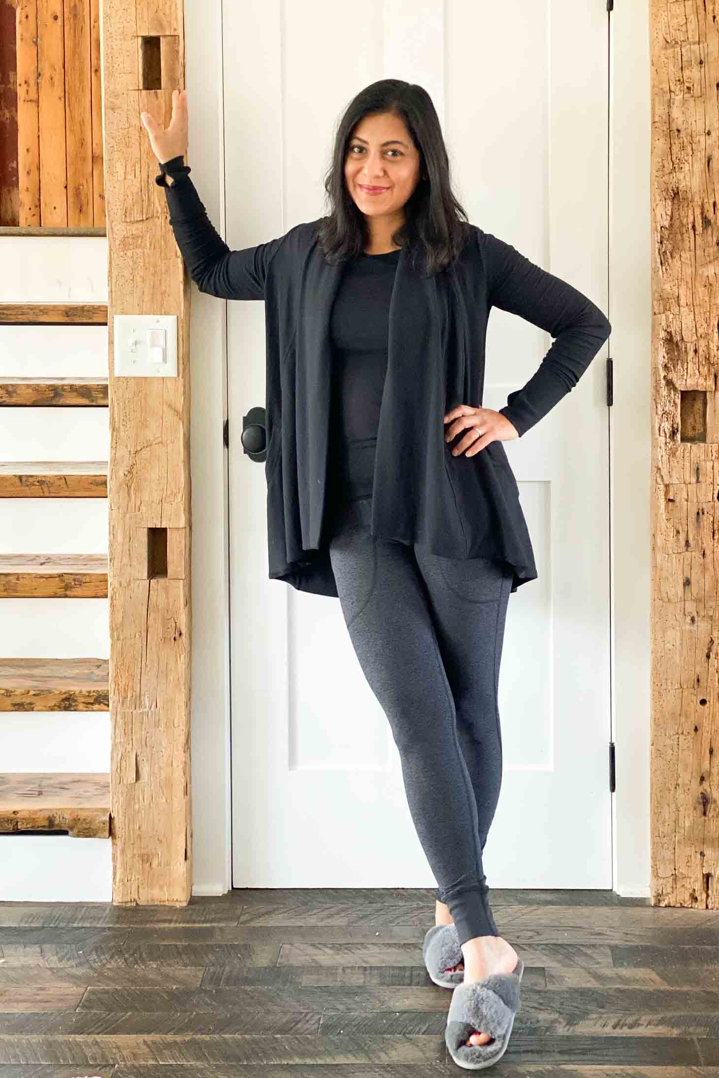 Fashionipa in a black t-shirt, open front wrap, charcoal leggings and faux fur slippers