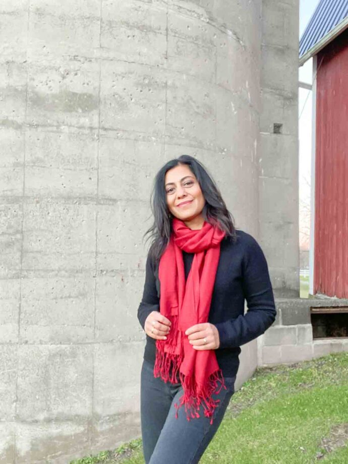 Fashionipa wearing a red scarf and black sweater