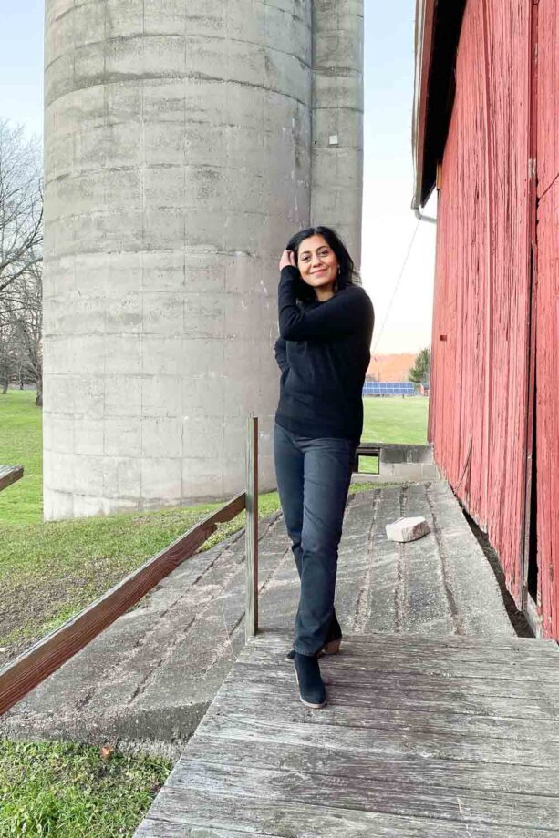 Fashionipa wearing a cashmere sweater and gray jeans with black boots