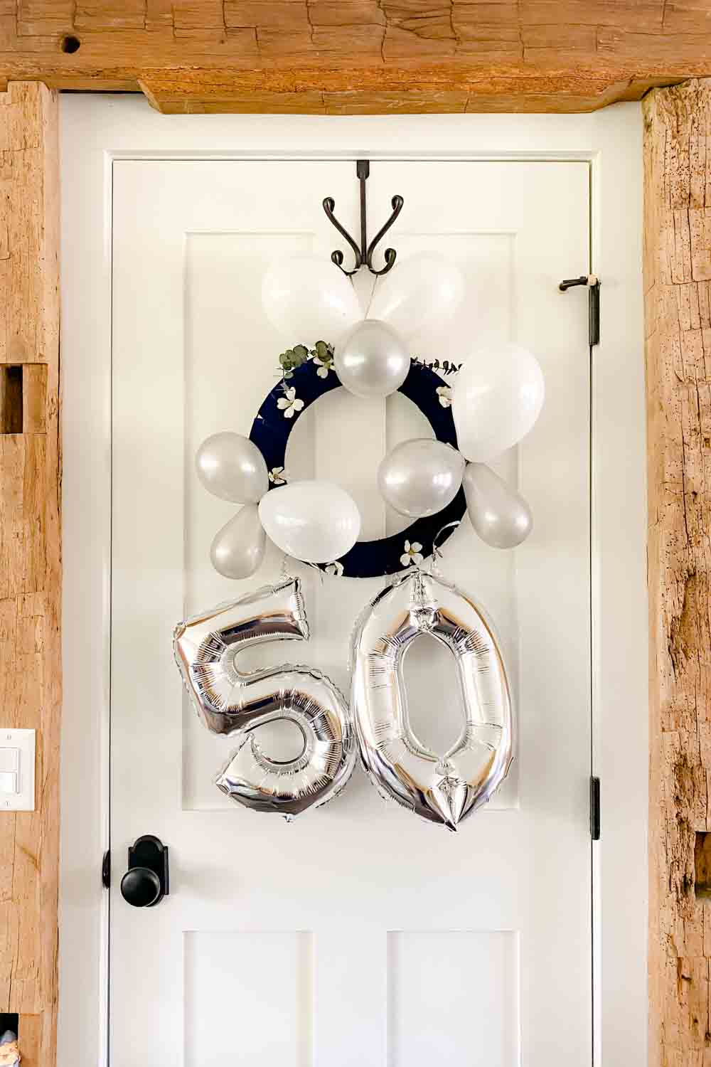5-0 baloons dangling from a balloon wreath