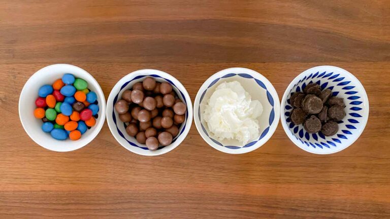Arrange sundae toppings for guests to help themselves: 4 bowls containing whipped cream, M&Ms, malt balls and peppermint patties.