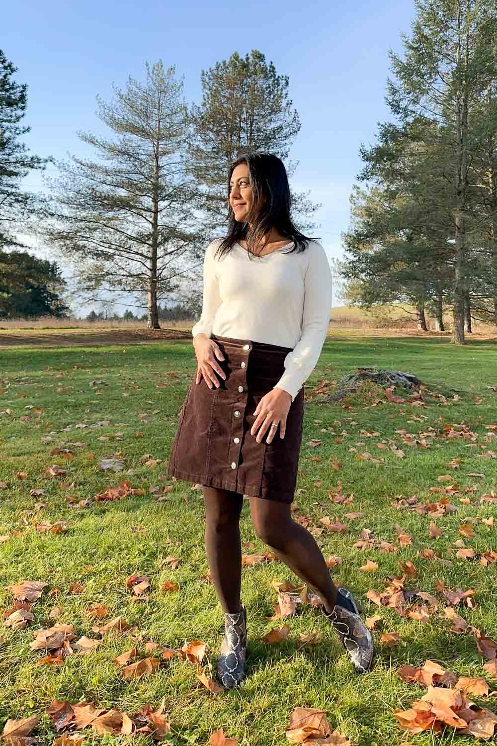 Fashionipa (Nipa) wearing an ivory v-neck sweater with a chocolate corduroy skirt, tights and snakeskin boots.