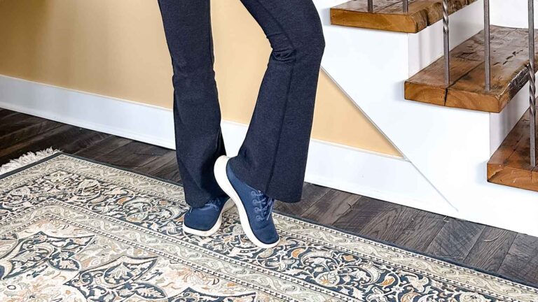 Image of a woman's legs wearing flare leggings and blue sneakers