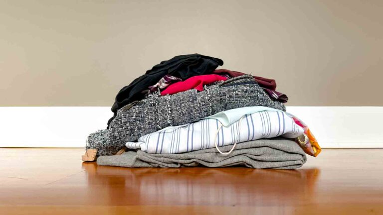 Pile of clothes on a wood floor.