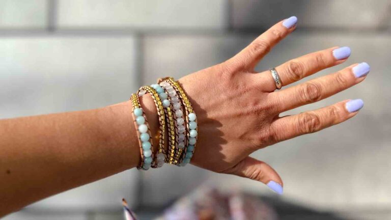 Image of a woman's left hand wearing a beaded wrap bracelet.