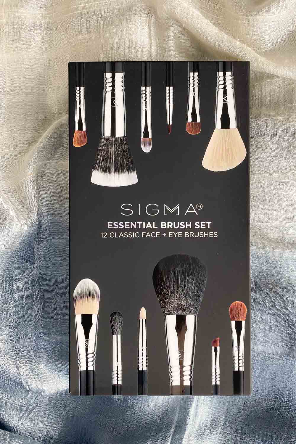 Image of box of Sigma makeup brushes on a blue and white scarf.