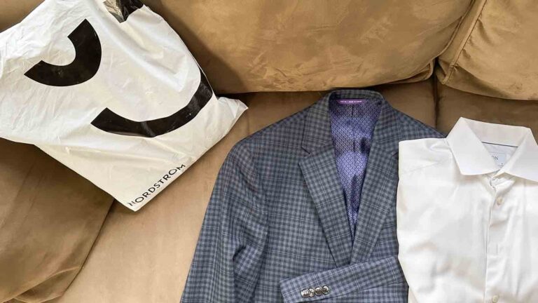 Image of a Nordstrom package, a check blazer and white shirt on a tan couch.