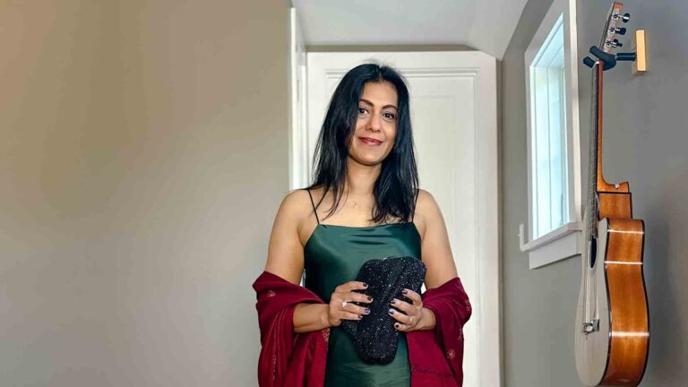 Fashionipa (Nipa) wearing a dark green slip dress with a burgundy wrap and a black clutch.