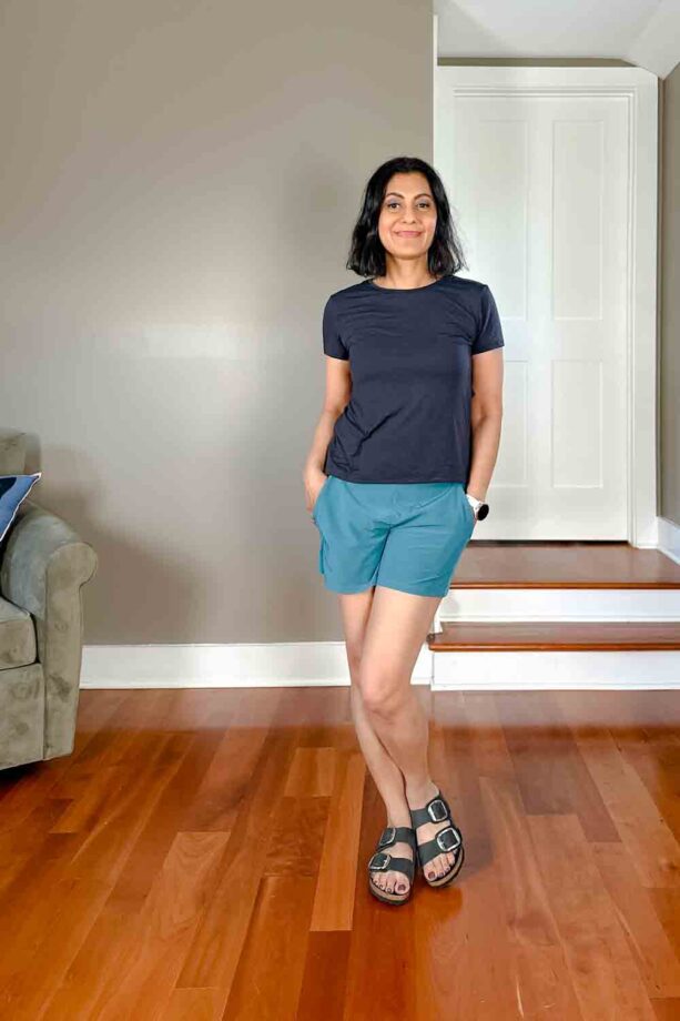 Fashionipa (Nipa) wearing a black short-sleeved t-shirt, blue-green shorts and Birkenstocks.