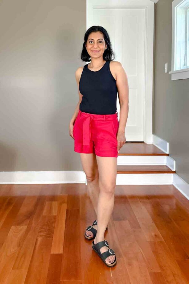 Fashionipa (Nipa) wearing a black cutaway tank, pink shorts and black Birkenstocks sandals.