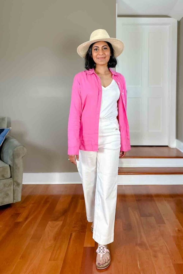 Fashionipa (Nipa) wearing a white t-shirt, white pants, pink Tory Burch Miller sandals, a pink linen shirt and a hat.