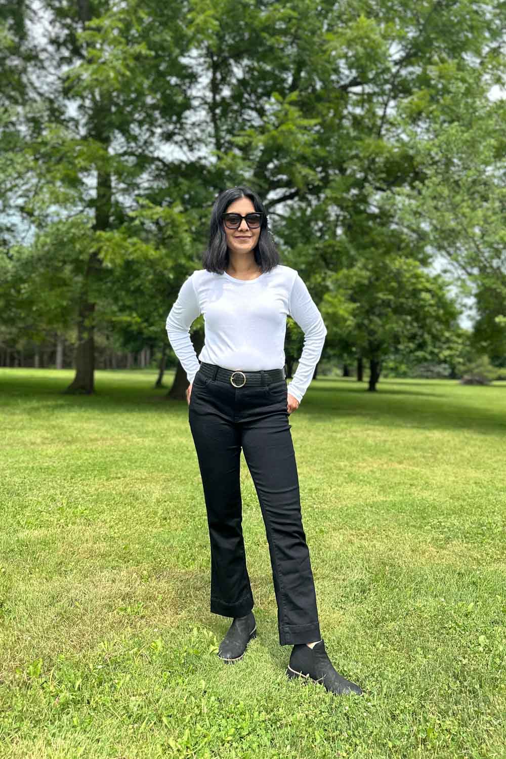 Fashionipa (Nipa) wearing a white long sleeved t-shirt, black jeans, a black belt and black boots. 