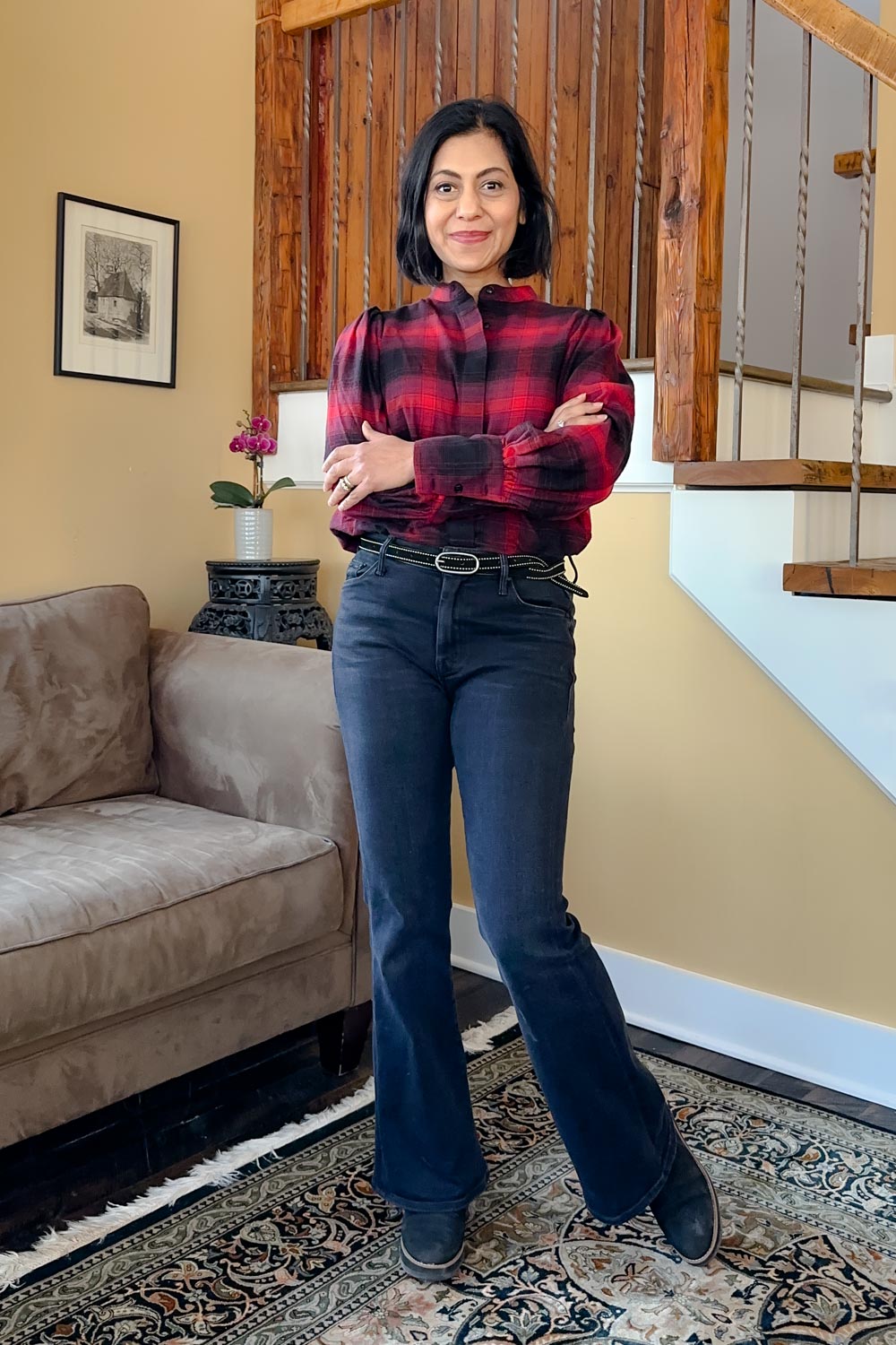 Fashionipa (Nipa) wearing black jeans, a red plaid shirt, a statement belt and boots.