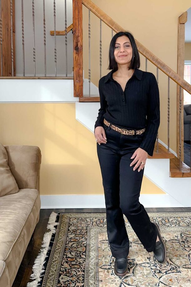 Fashionipa (Nipa) wearing a black polo sweater with black jeans, a leopard belt, and lug sole loafers.