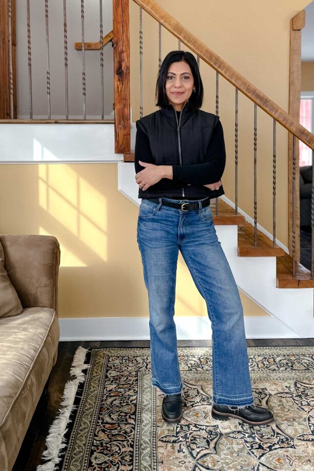 Fashionipa (Nipa) wearing a black modk neck t-shirt, cropped puffer vest, cropped jeans and a wide belt.