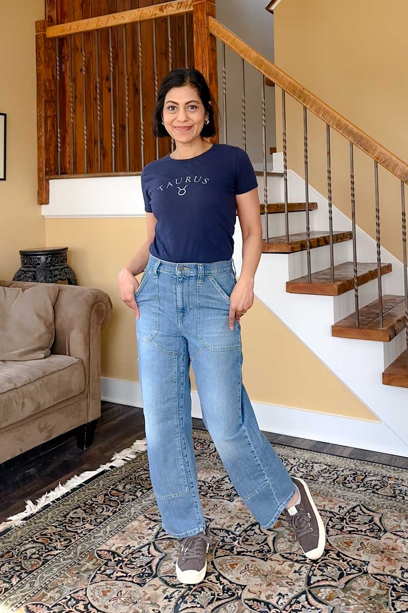 Fashionipa (Nipa) wearing a navy t-shirt with the word Taurus prtinted in white, utility jeans and chocolate sneakers.