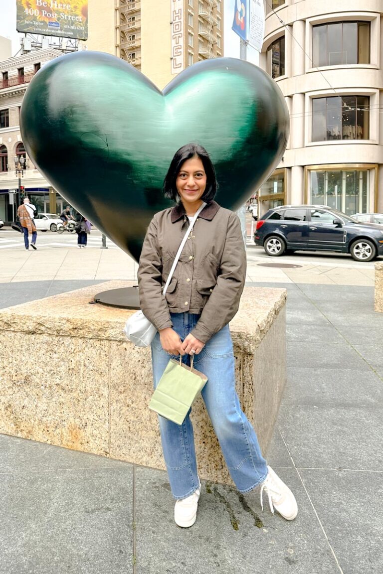 Fashionipa (Nipa) wearing a brown jacket with jeans and white/beige sneakers.