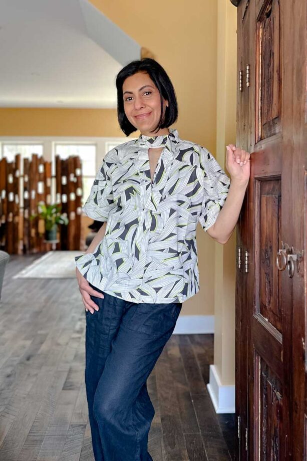 Fashionipa (Nipa) wearing a cotton poplin tie-neck top in a black, white and green print.
