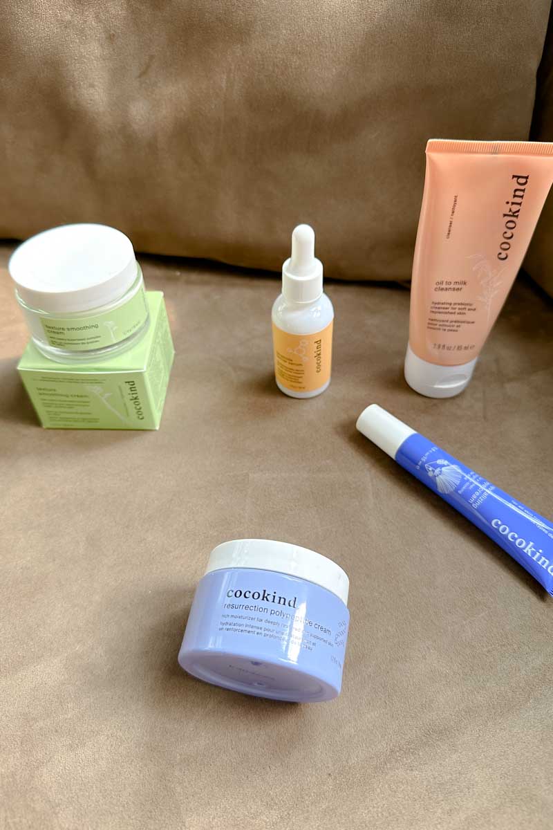 5 Cocokind products on a tan couch