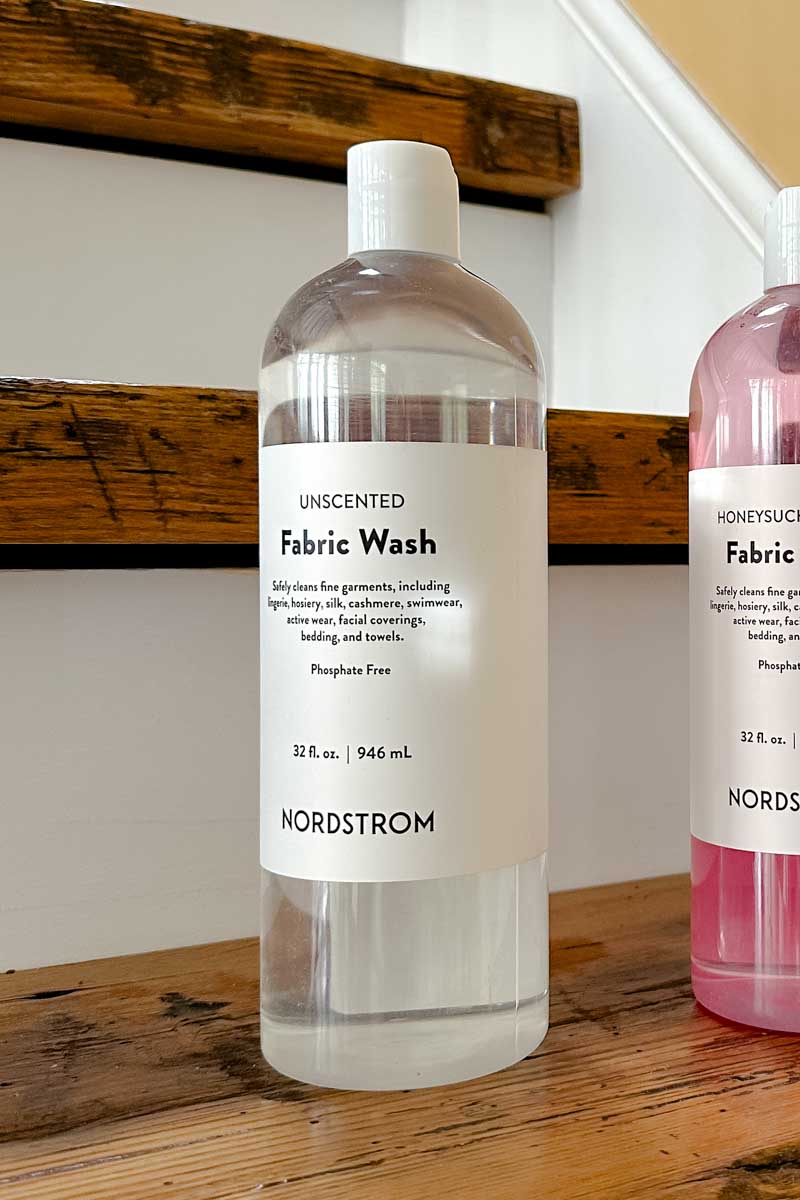 Two bottles of Nordstrom Delicate wash on a wooden step.