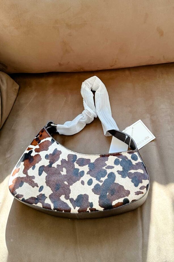 Asymmetrical shoulder bag with a black, brown and white cow print