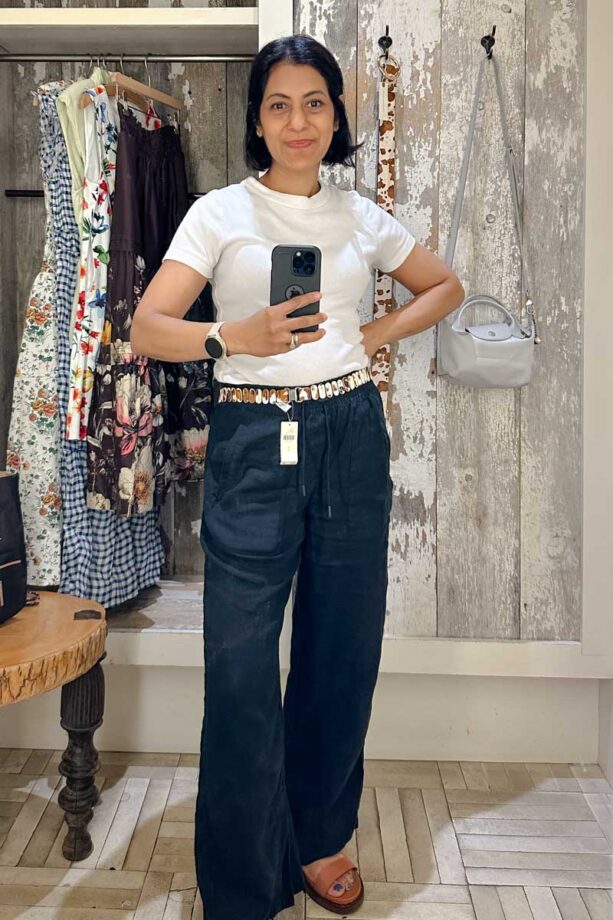 Fashionipa (Nipa) wearing a white t-shirt, black linen pants and cow print belt.