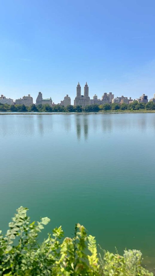 View of buildings across the Reservoir in Central Park, New York City.