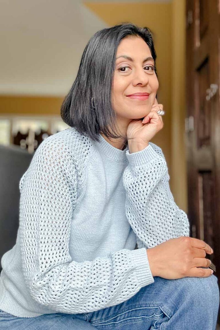 Fashionipa (Nipa) wearing a pale blue cotton sweater with open weave sleeves.