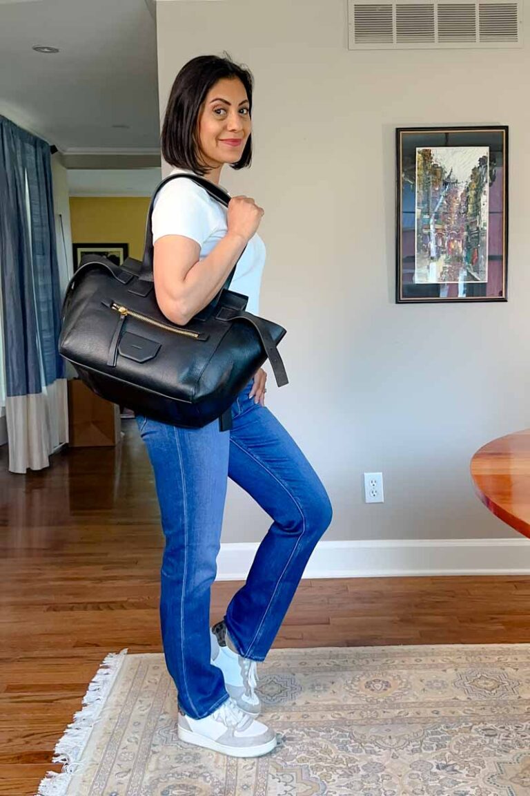 Fashionipa (Nipa) wearing a white t-shirt, jeans, carrying a large black leather tote.