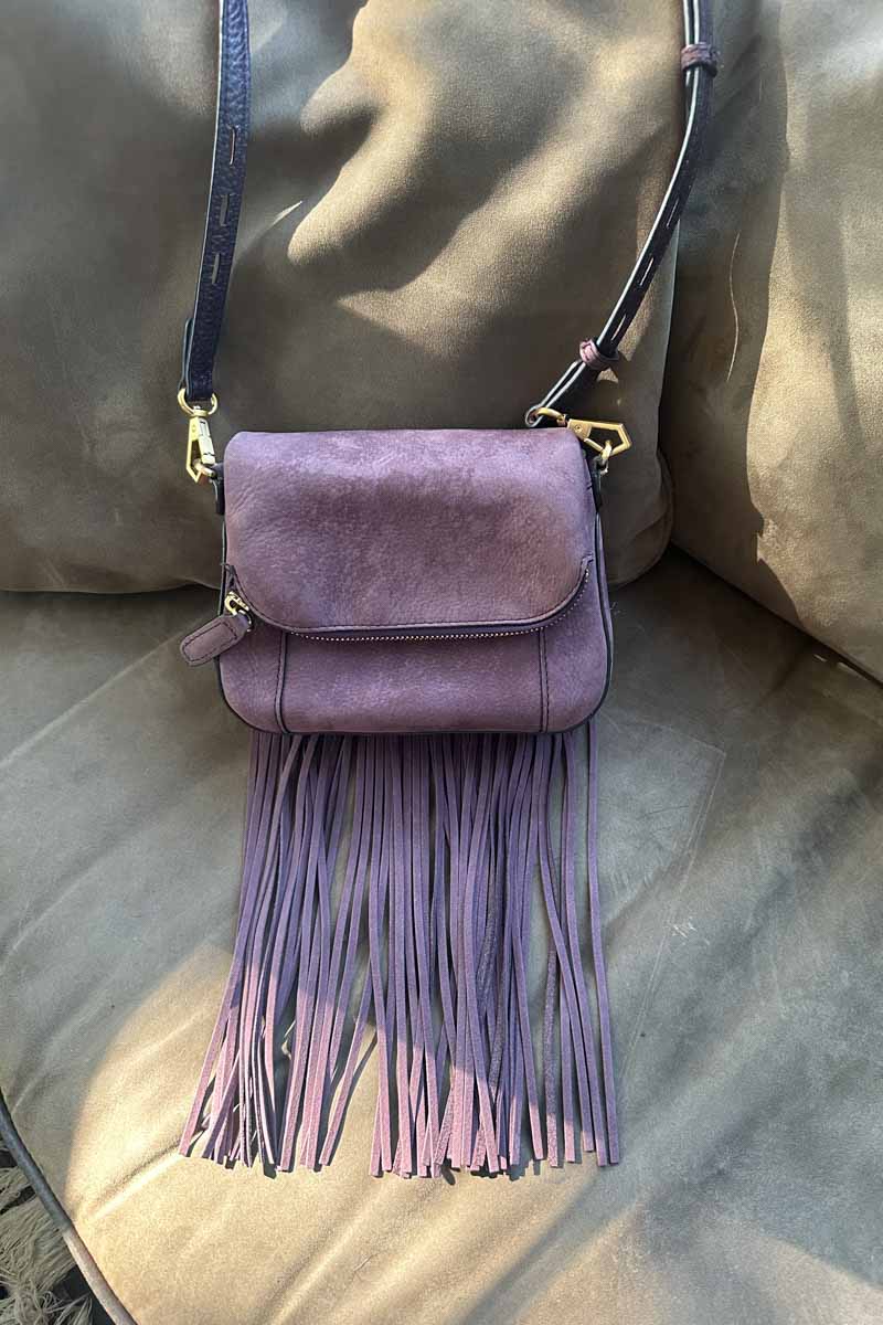 Dark purple saddle bag with with fringe. 