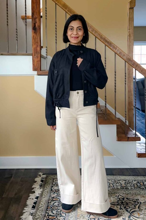 Fashionipa (Nipa) wearing a black mock-neck t-shirt with cream jeans and a black cropped jacket.