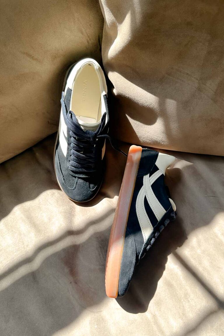 Black suede sneakers with cream design on the sides.