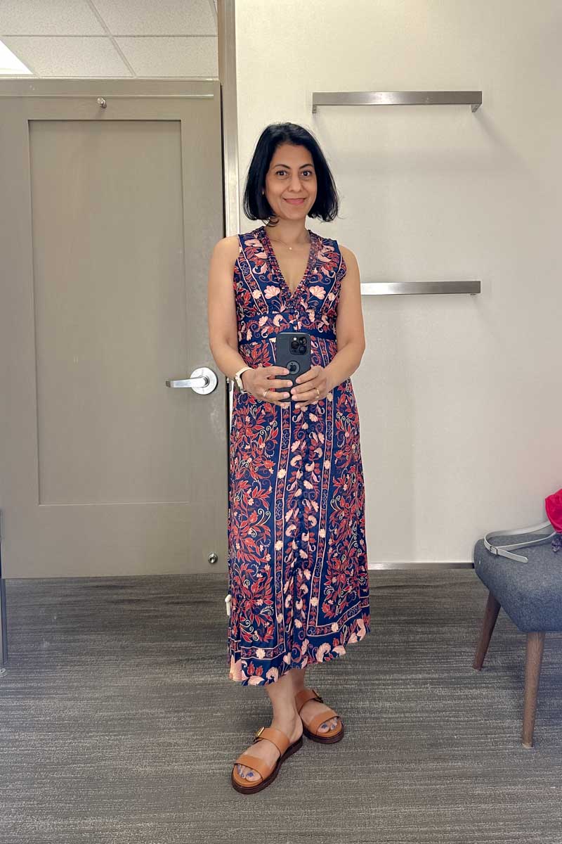 Fashionipa (Nipa) wearing a navy floral sleeve less dress.