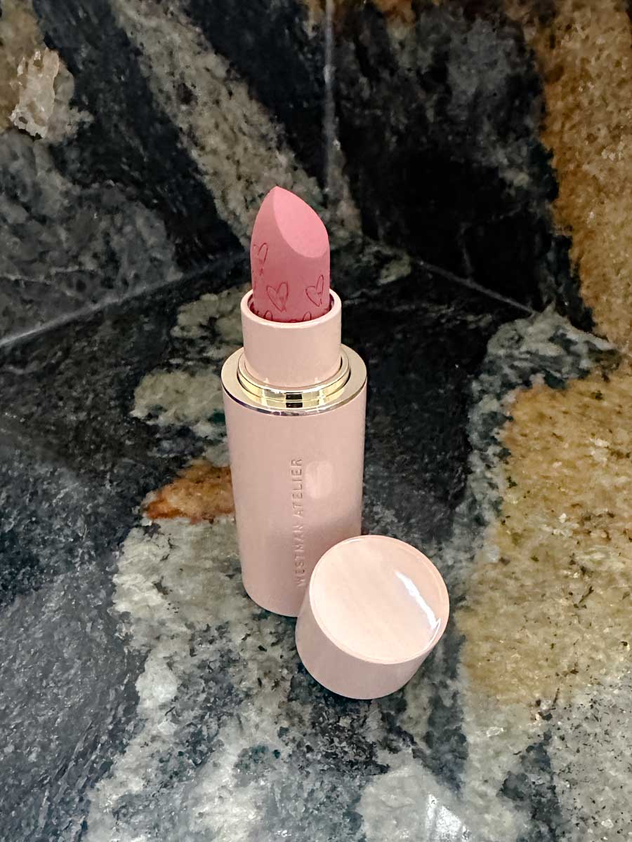 Westman Atelier's pink lipstick on a marble counter