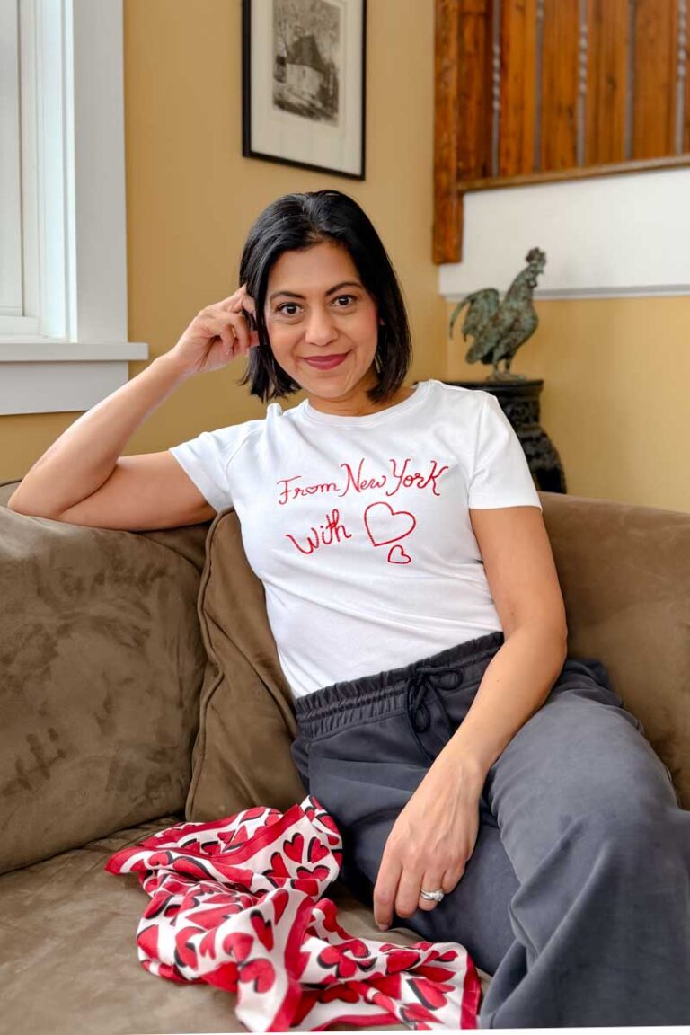 Fashionipa (Nipa) wearing a white tee tat has "From New York With Love" embroidered in red. Next to her is a heart print scarf.