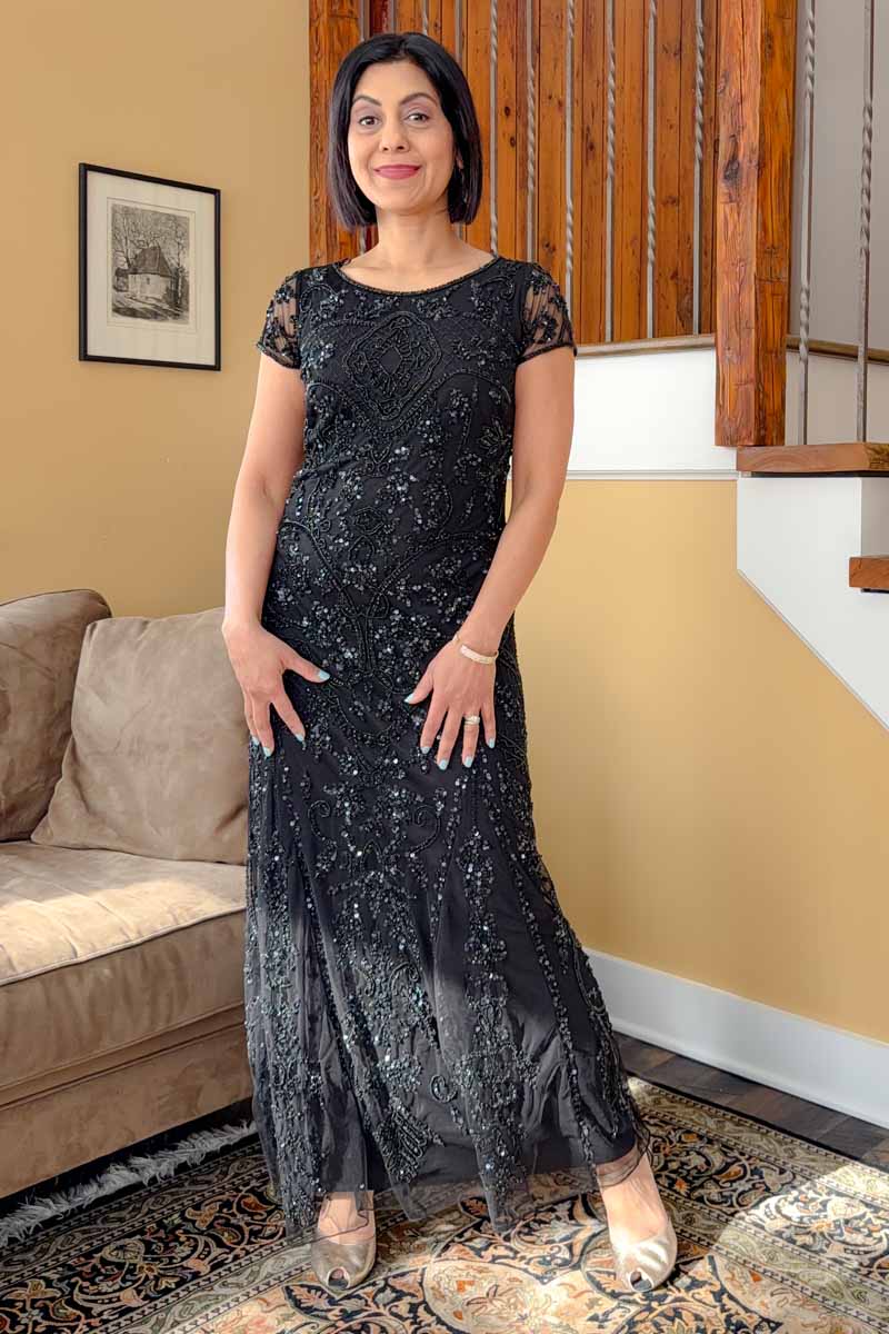 Fashionipa (Nipa) in a black beaded gown and gold shoes.