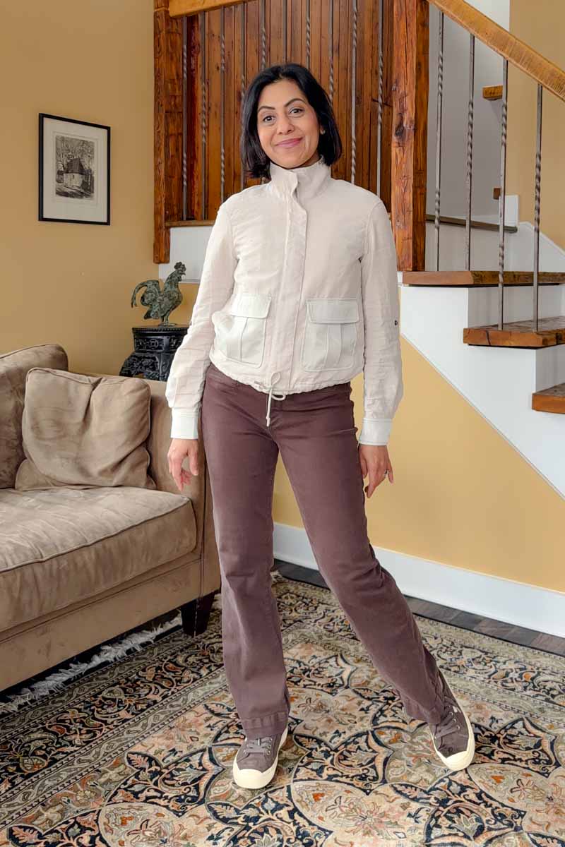 Fashionipa (Nipa) wearing a beige funnel-neck jacket with brown pants and sneakers. 