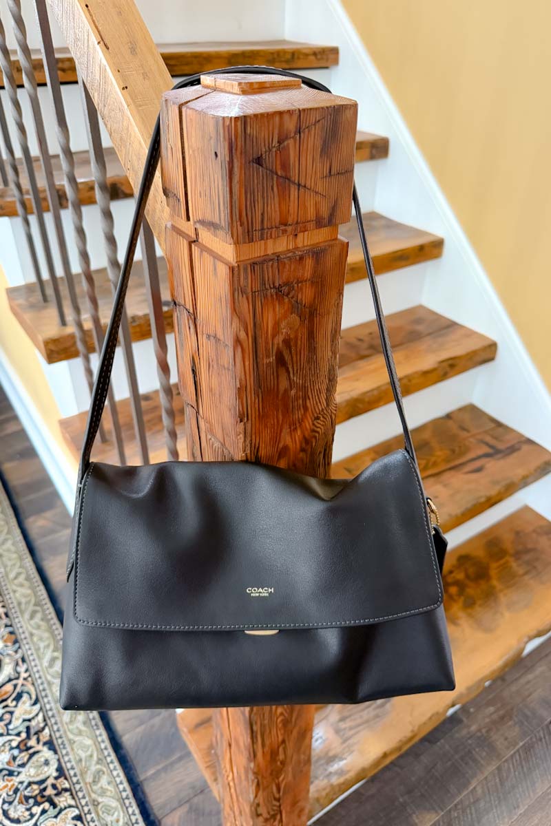 Coach Chelsea 30 in black hanging on a post