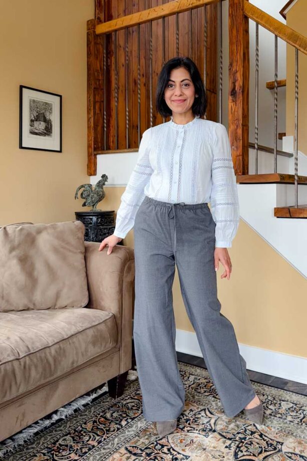 Fashionipa (Nipa) wearing a light blue blouse with pintucks and lace trim with gray wideleg pants and gray pointed toe heels.