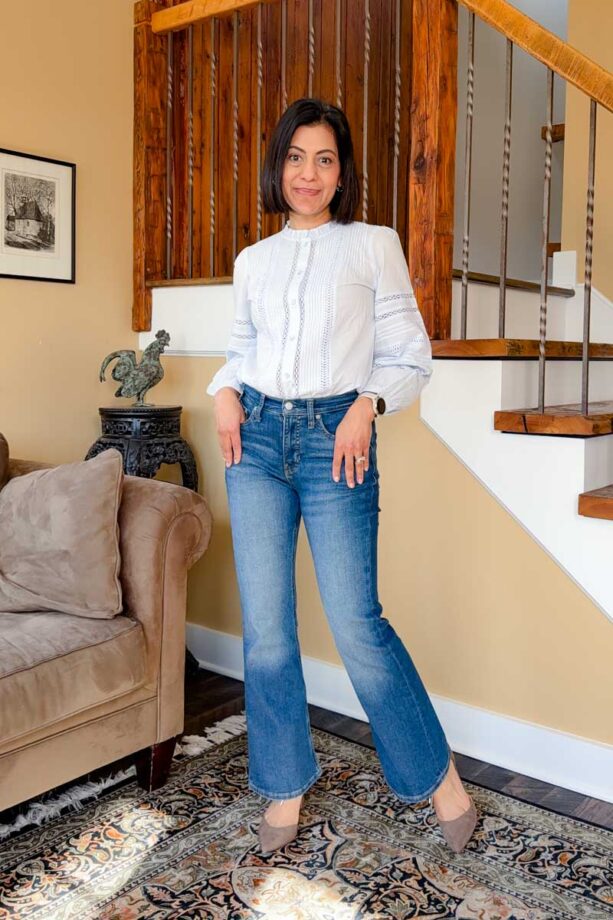 Fashionipa (Nipa) wearing a light blue blouse with pintucks and lace trim with flared jeans and taupe pointed toe heels.