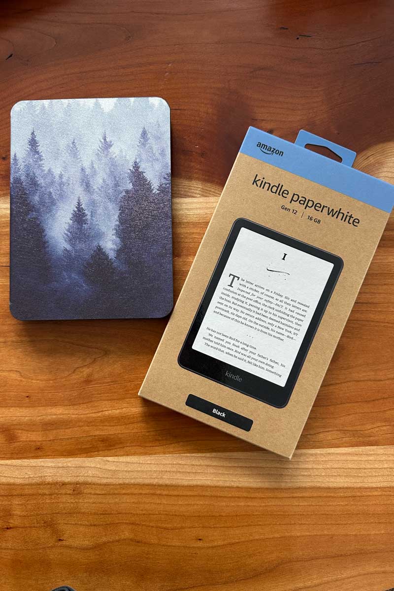 Kindle Paperwhite and a cover with a blue/gray tree print.