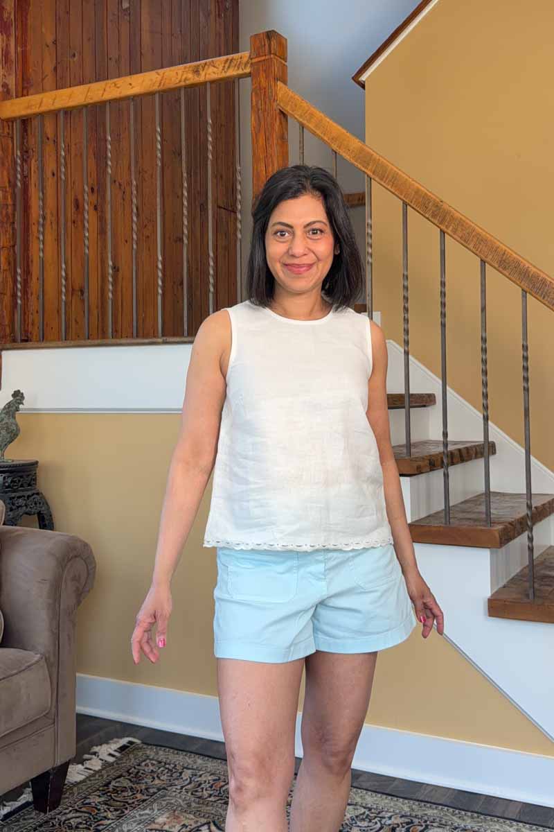 Fashionipa (Nipa) wearing an ivory linen top with scalloped border over blue shorts